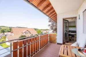a balcony with a view of a house at Hofquartier in Kappelrodeck