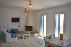 a living room with a couch and a table at White Blue Houses & Apartments Paros in Parikia