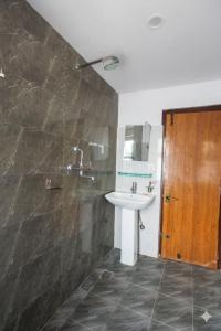 a bathroom with a sink and a mirror at Hotel In N Out in Kathmandu