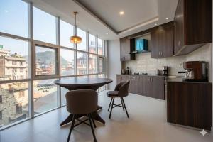 a kitchen with a table and chairs in a room at Hotel In N Out in Kathmandu