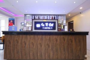 a bar with a television on top of it at Hotel In N Out in Kathmandu +11 photos