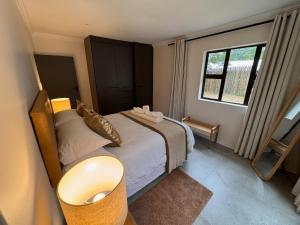 a small bedroom with a bed and a window at First Light Serenity in Hluhluwe +59 photos