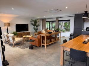 a living room with a couch and a table at First Light Serenity in Hluhluwe