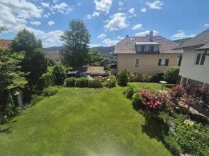 a yard with flowers and a house at Dein Zuhause am See in Millstatt