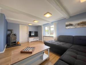 a living room with a couch and a tv at Haus-Min-Leevstes in Böhl