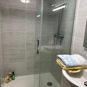 a shower with a glass door next to a sink at La Maisonnette in Cellettes +27 photos
