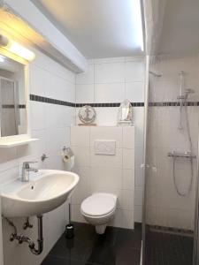 a bathroom with a sink and a toilet and a shower at Haus-Min-Leevstes in Böhl +28 photos