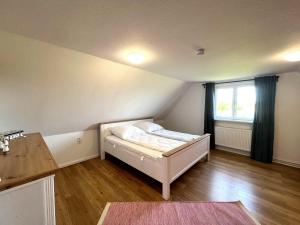 a small bedroom with a bed and a window at Haus-Min-Leevstes in Böhl