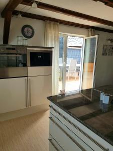 a kitchen with white cabinets and a counter top at Pferdeglück in Remptendorf