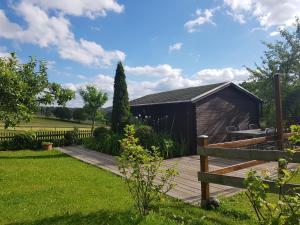 a garden with a wooden deck and a shed at Pferdeglück in Remptendorf +10 photos