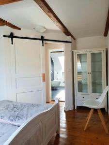 a bedroom with a bed and a bathroom with a tub at Pferdeglück in Remptendorf