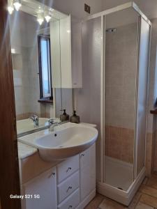 a bathroom with a sink and a shower at Casale Montanari in Matigge +30 photos