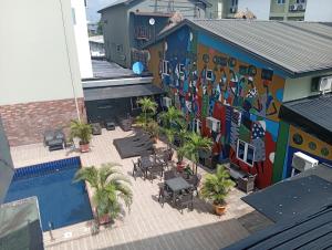 a mural on the side of a building with a pool at Visa Karena Hotels in Port Harcourt