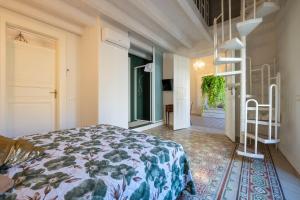 a bedroom with a bed and a staircase in it at Chez Moi in Trapani