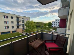 a balcony with a bench and a chair on a building at Richie Apartment near Aquapark in Prague