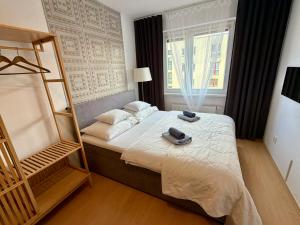 a bedroom with a bed and a window at Richie Apartment near Aquapark in Prague