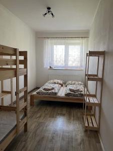 a bedroom with a bed and two bunk beds at Nutilova chalupa in Jindřichŭv Hradec