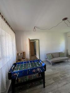 a room with a pool table in the middle of a room at Nutilova chalupa in Jindřichŭv Hradec