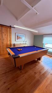a pool table in the middle of a room at Sunset Beach Self-Catering in Marina da Gama
