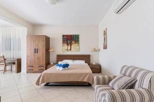 a bedroom with a bed and a couch at Villa Seliora in Sivota +35 photos