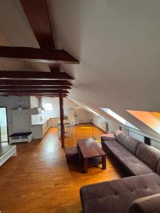 a living room with a couch and a table at Dworek in Szonowice