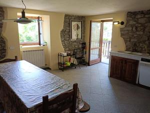 a kitchen with a table and a dining room with a tableablish at The Old Barn by Roby in Saint Vincent +20 photos