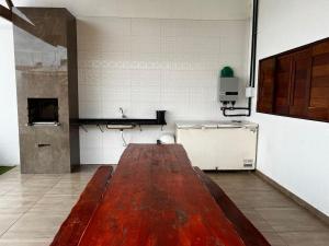 a room with a large wooden table in a kitchen at Lotus Beach in Piaçabuçu