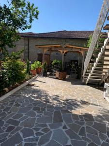 an outdoor patio with a stone walkway and stairs at Casa Ortensia in Chiusi della Verna