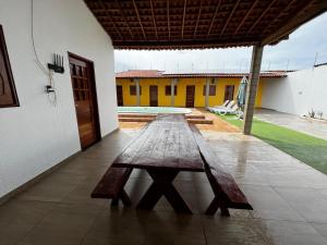a wooden table sitting in the middle of a patio at Lotus Beach in Piaçabuçu
