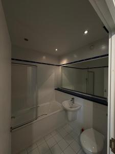 a bathroom with a tub and a toilet and a sink at Beautiful 2 Bedroom - Woolwich in Woolwich