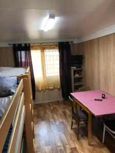 a small room with a table and a bed at Chalmová CHATA 27 in Bystričany