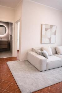 a living room with a white couch and a rug at Monte Aria panorama suites in Herceg-Novi