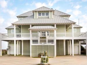 a large house with a gambrel roof at Moss Landing Luxury Beachfront Private Walkover in Bolivar Peninsula