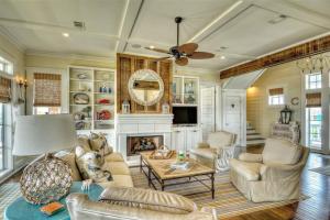 a living room filled with furniture and a fireplace at Moss Landing Luxury Beachfront Private Walkover in Bolivar Peninsula