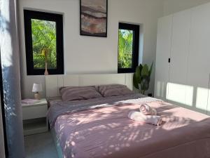 a girl laying on a bed in a bedroom at Noir Blanc Modern Villa in Ko Phangan +70 photos
