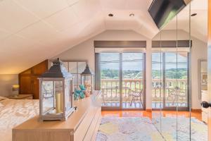 a bedroom with a bed and a balcony at La Centinela en Costa Quebrada in Miengo