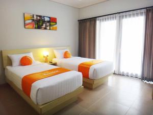Postel nebo postele na pokoji v ubytování Tropico Jimbaran Bali + 18 fotografií
