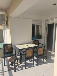 a table and chairs sitting on a patio at Nana apartment in Perea +6 photos