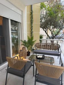 a patio with chairs and a table on a balcony at DD apartments & suites in Paralia Katerinis
