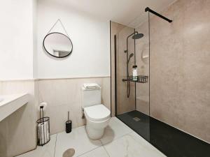 a bathroom with a toilet and a glass shower at Sea View - Pool view - Beach Front - 25 meter to beach in Málaga