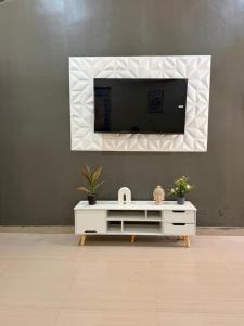 a living room with a tv and a white cabinet at Jfk3 in Ouagadougou