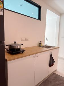 a kitchen with a counter top with a pan on it at 2 Bed & 2 Bath Suite, 4th floor in Ban Bang Toei (1)