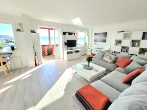 a living room with a couch and a table at Beautiful panoramic apartment in Vestnes