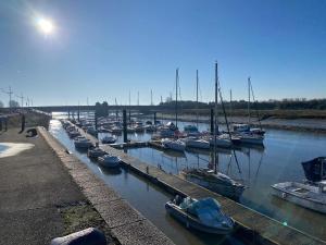 a bunch of boats are docked in a harbor at Maison de pêcheurs les petits quinquins in Étaples