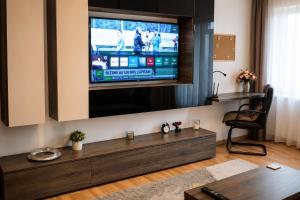 a living room with a flat screen tv on a wall at Adrian Home Libra in Ploieşti