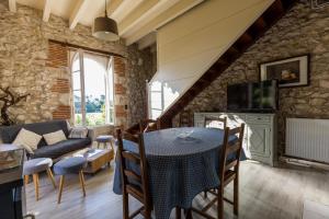 a living room with a table and a couch at La tour du manoir in Arouille