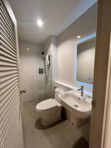 a bathroom with a toilet and a sink and a shower at 2 Bed & 2 Bath Suite, 4th floor in Ban Bang Toei (1) +34 photos