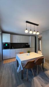 a kitchen with a table and some lights and a kitchen at Casa Marika in Valdisotto