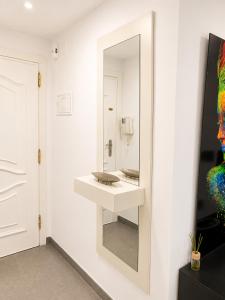 a bathroom with a mirror and a sink at Seaside Apartment Retreat in Benicàssim +35 photos