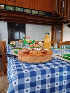 a table with a cake on a blue and white table cloth at Alloggio agrituristico Zambon in Vedelago